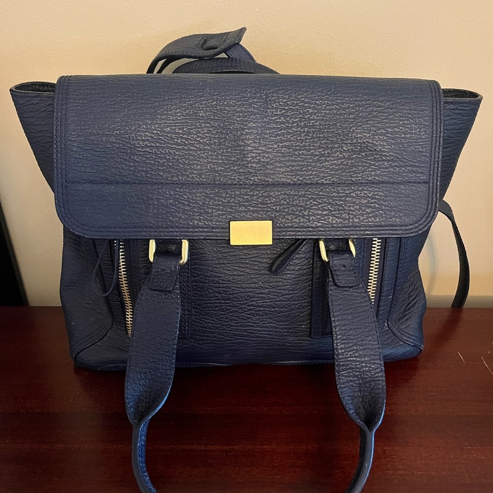 Pebbled leather with fabric and leather lining. Hardly worn